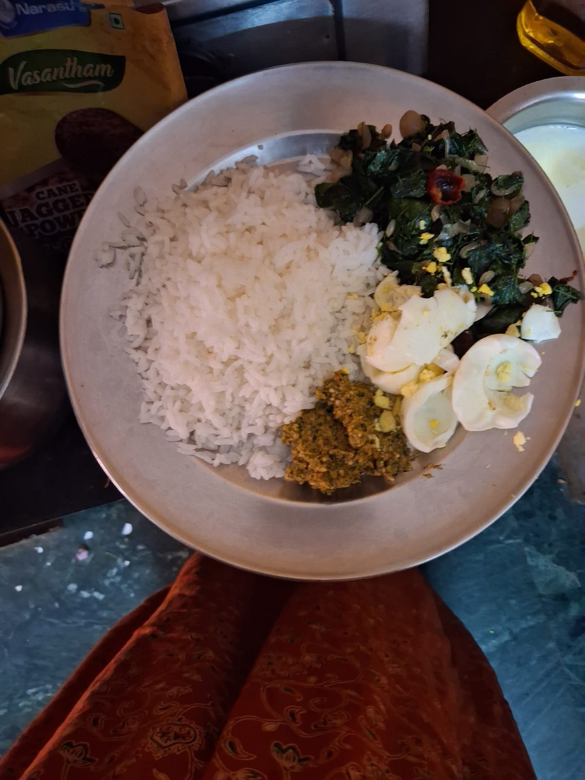 Chellammal's meal plate with rice, sauteed greens, boiled eggs and a side of chutney