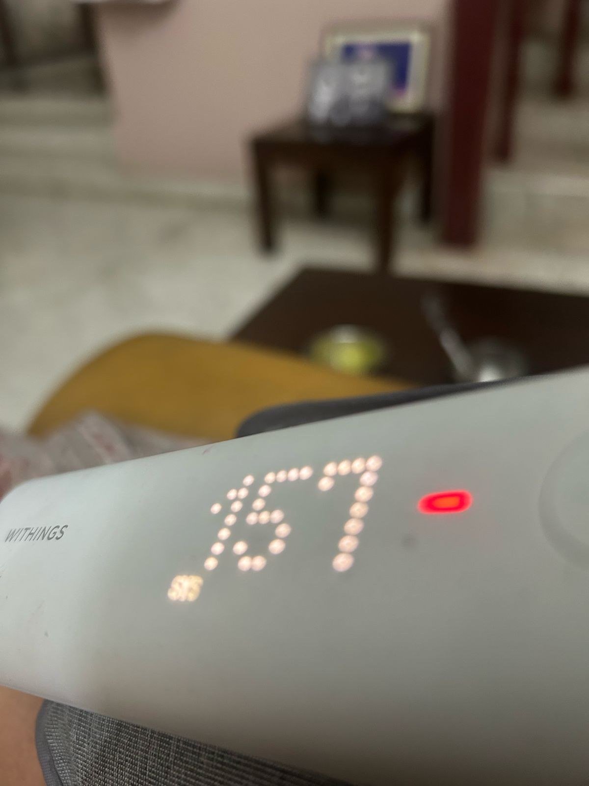 Withings BP monitor showing systolic reading of 167, with red high-reading indicator visible